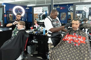 Barbers cut hair at Kuttz